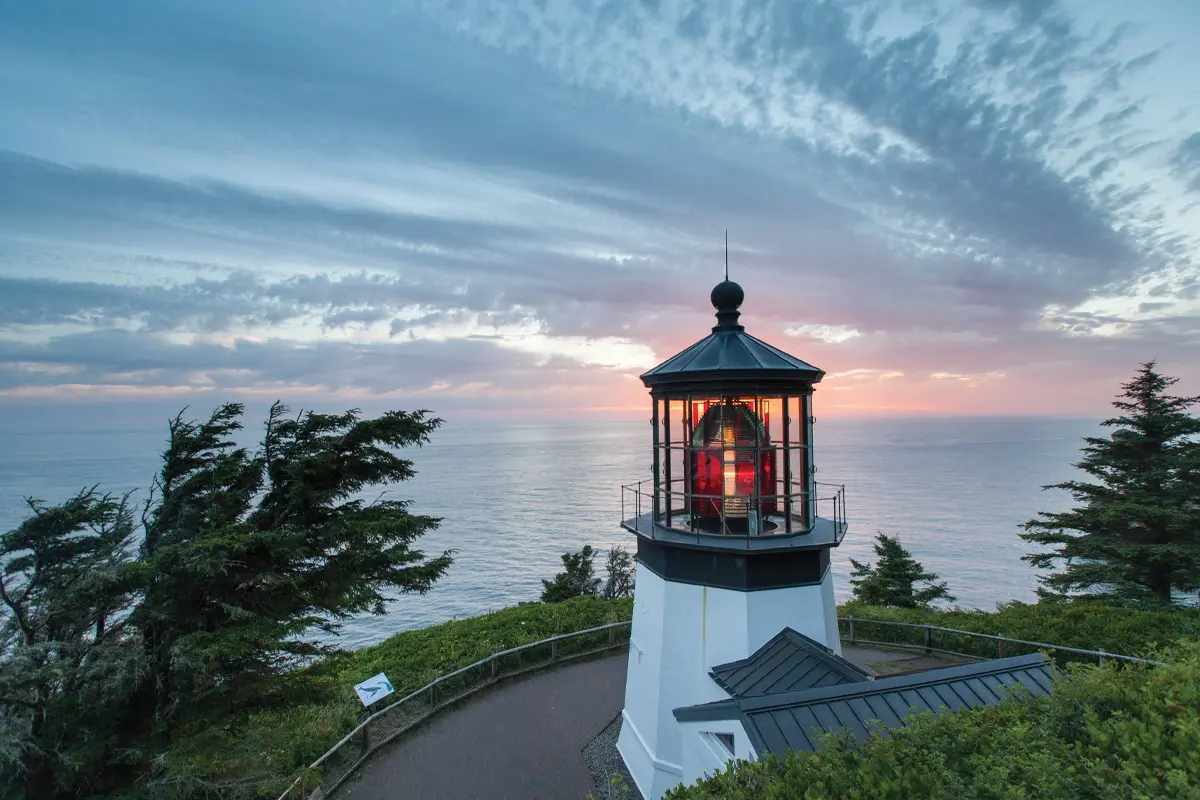 Cape Meares Lighthouse, the historic 38-foot lighthouse on the Oregon Coast just north of Oceanside, with red lantern room atop a white brick tower
