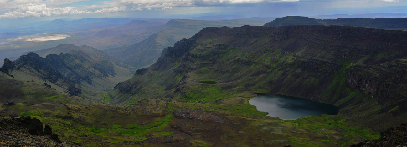 Steens Mountain rising abruptly from the Alvord Desert in southeastern Oregon, with snow on the upper slopes and sagebrush in the foreground