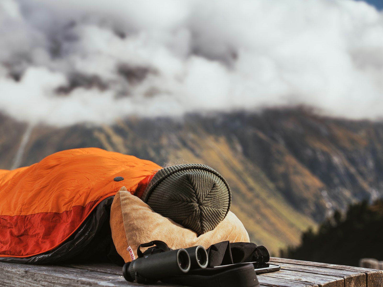 Backpacking sleeping bag unrolled and ready for comparison next to a packed trail kit