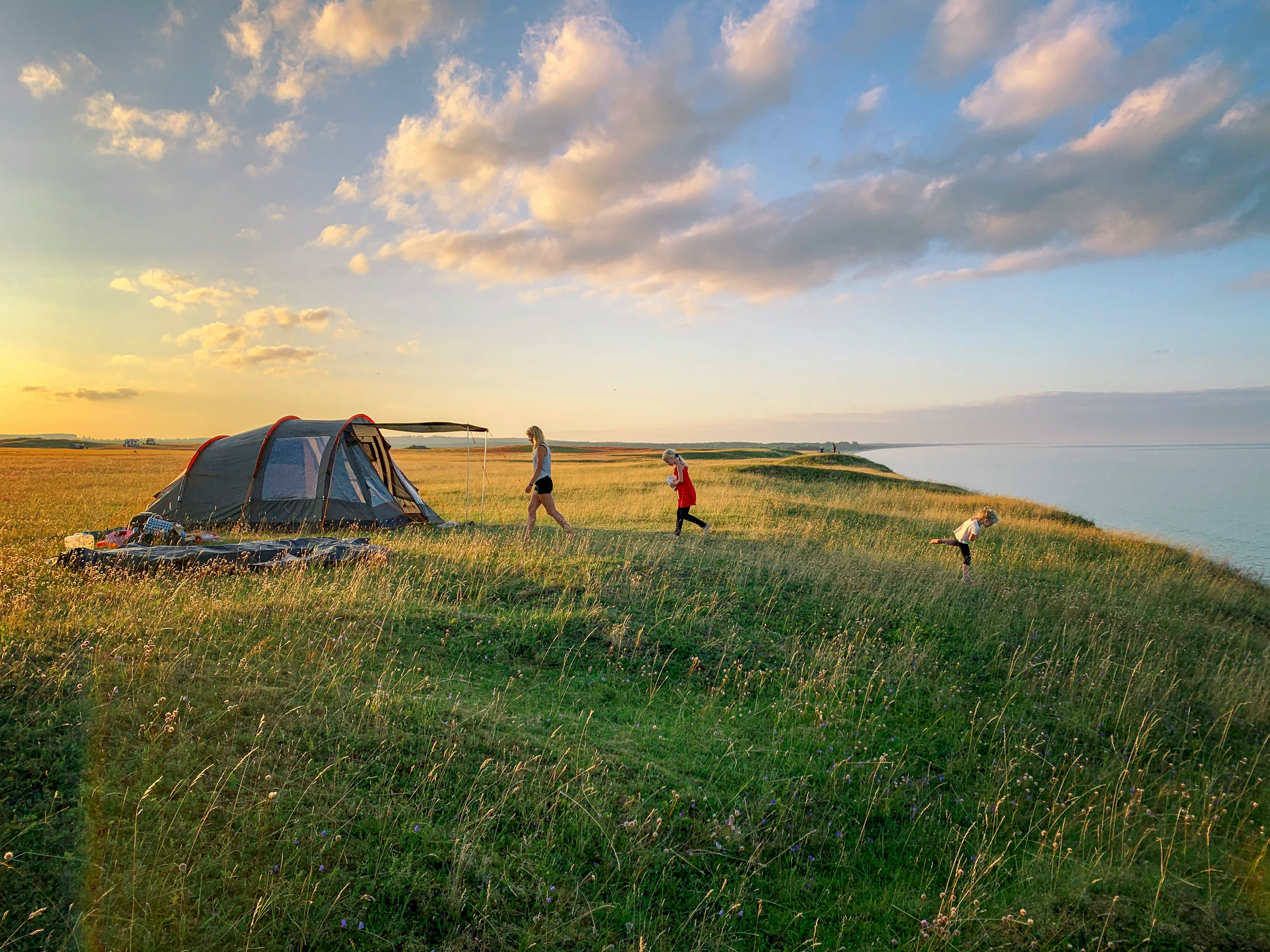 A campsite at golden hour in Oregon, tent pitched among Douglas firs