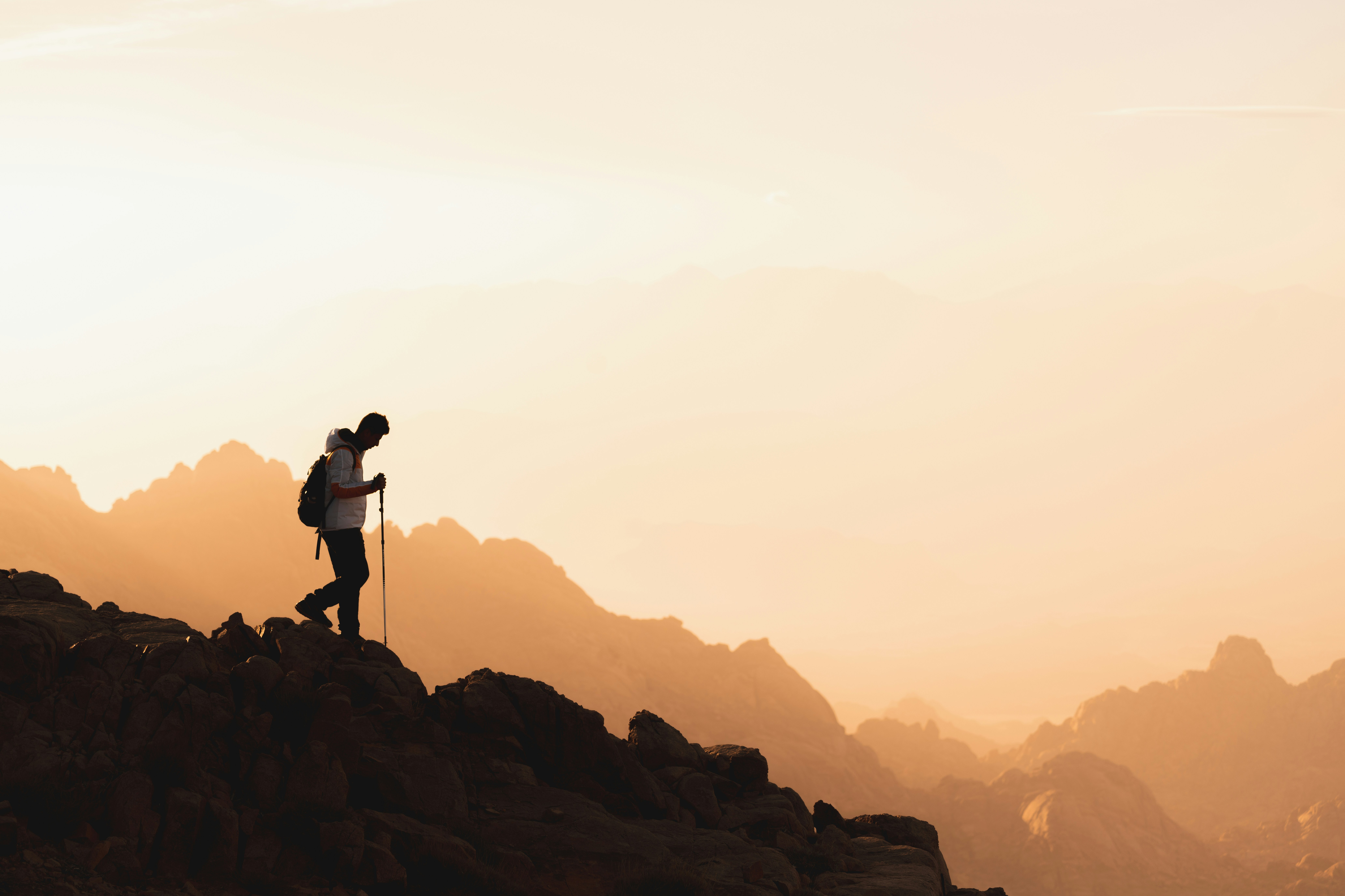 Hiker wearing waterproof boots on a trail at sunrise