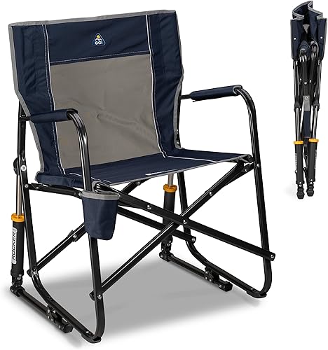 GCI Outdoor Freestyle Rocker camping chair beside a fire ring at a primitive site